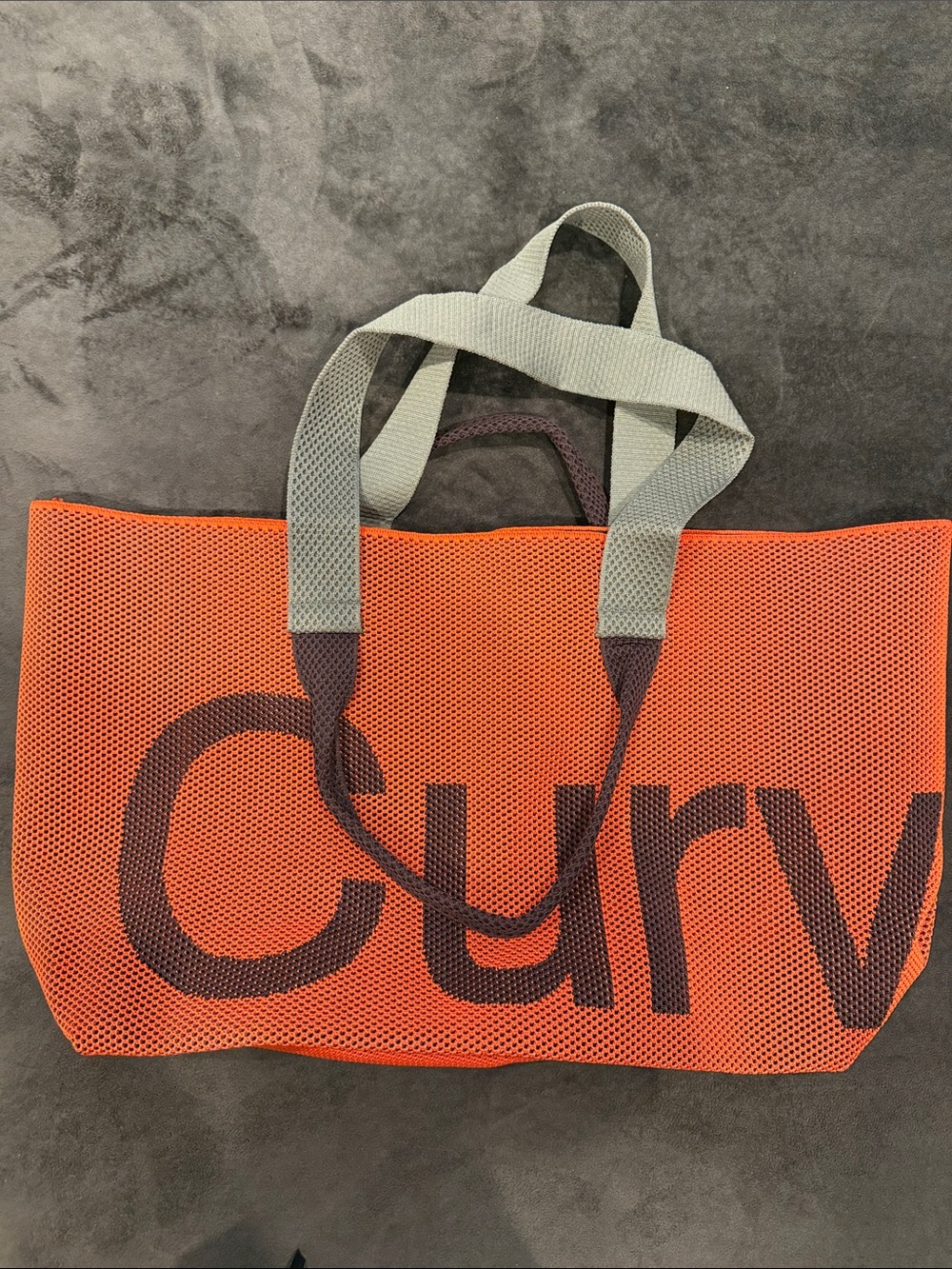 Bold Orange Mesh Tote with Gray Handles and Contrasting Logo